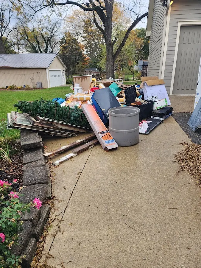 Dumpster being loaded with debris for 3 Yard Dumpster Rental in Meadow Oaks